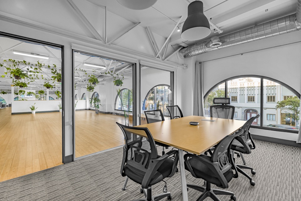 Bright furnished room with large windows and comfortable seating